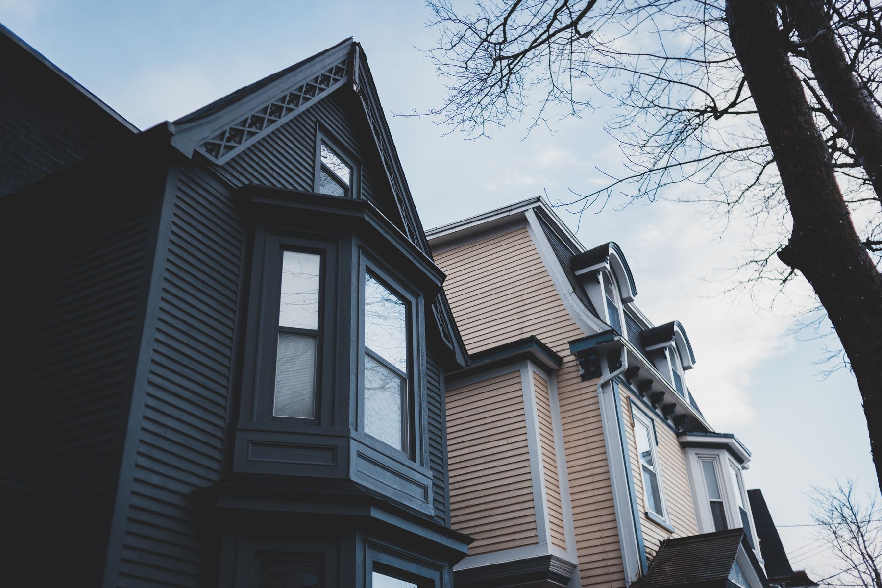 Residential home exterior showing roofing, siding, gutters, and windows.